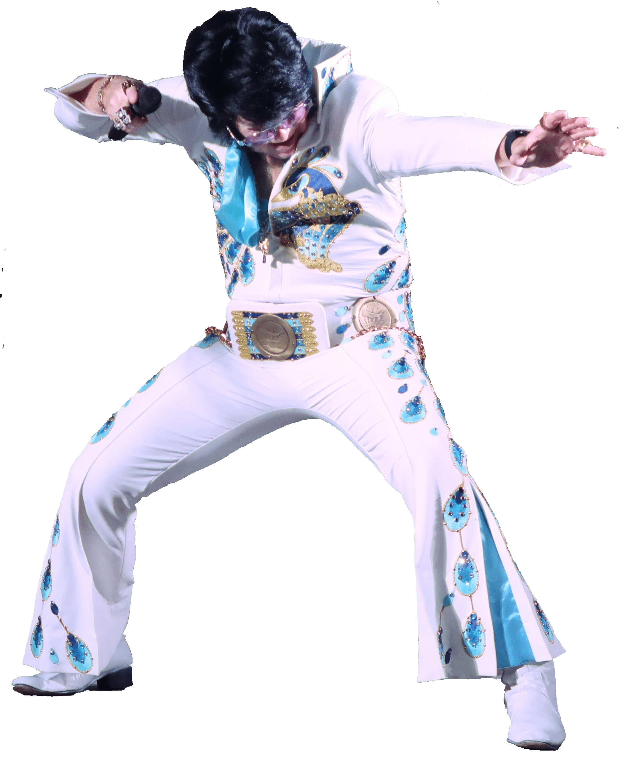 A performer dressed as Elvis Presley in a white jumpsuit with blue embellishments striking a dynamic pose, showcasing their passion for rock and roll.